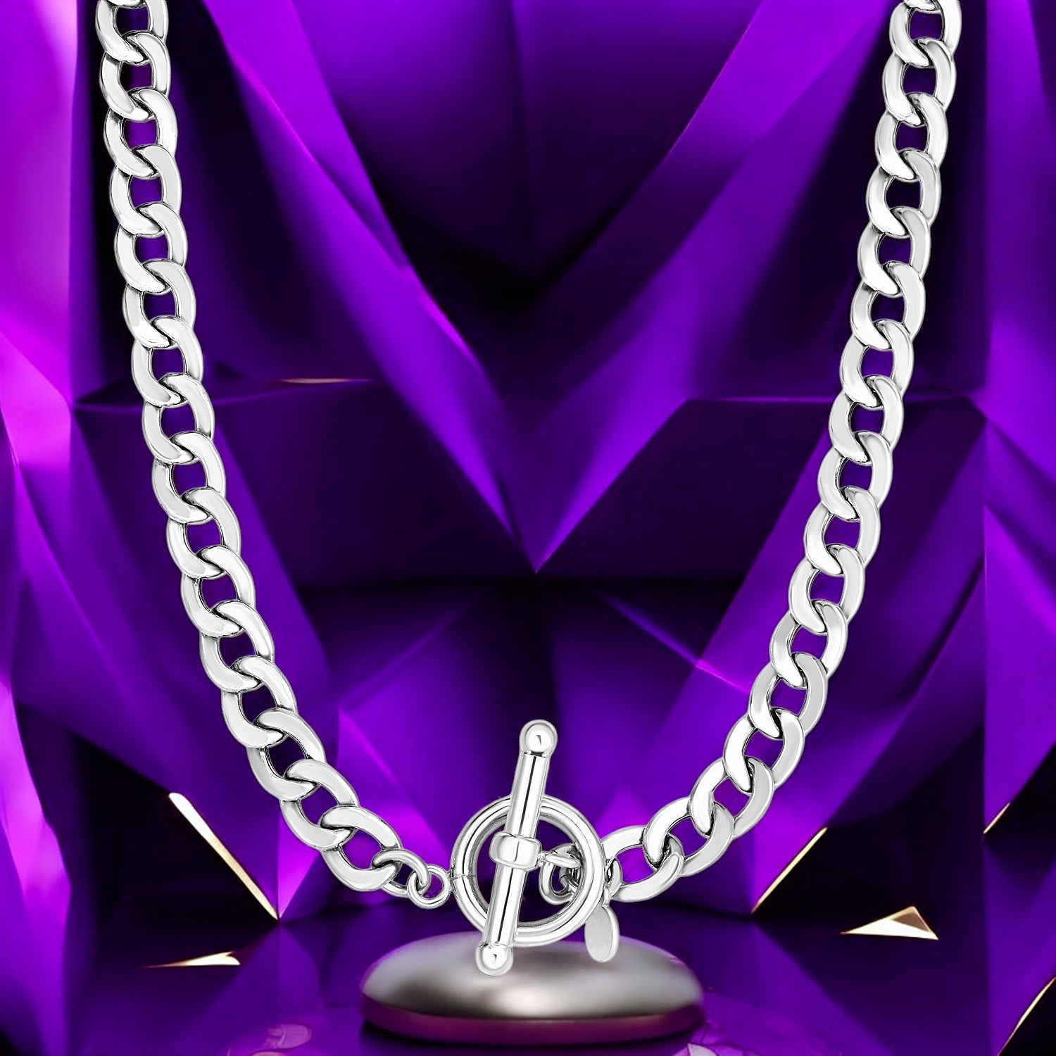 "Elegant silver chain necklace with toggle clasp against a vibrant purple background."